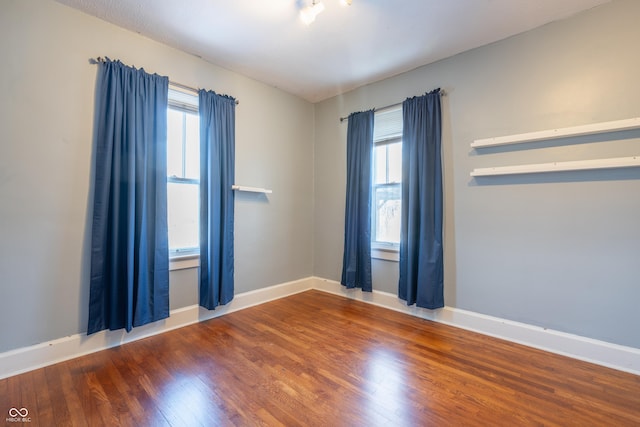 empty room featuring dark hardwood / wood-style flooring