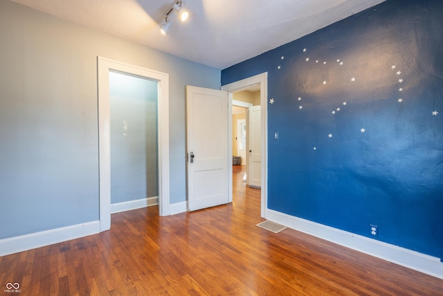 unfurnished room featuring hardwood / wood-style flooring