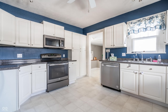 kitchen featuring sink, white cabinetry, and stainless steel appliances