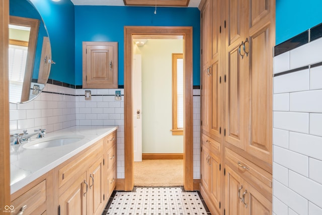 bathroom with tile walls and vanity