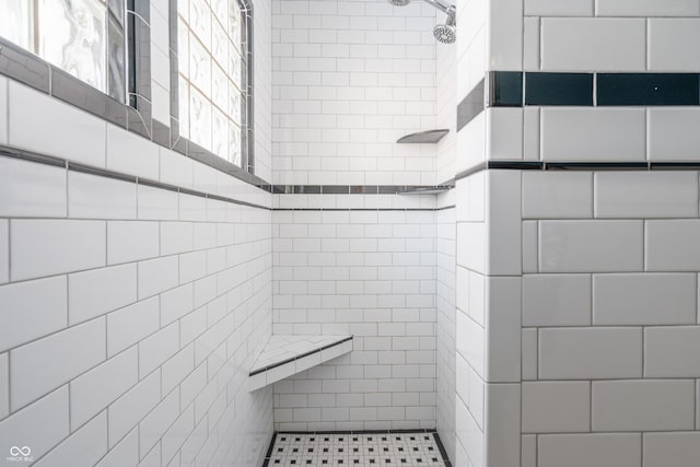 bathroom with tiled shower