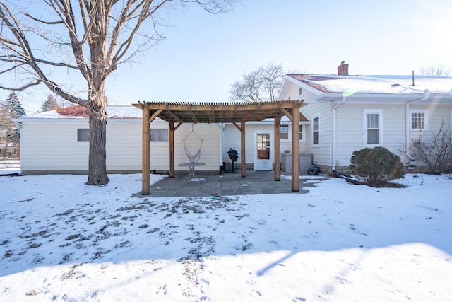 view of snow covered rear of property