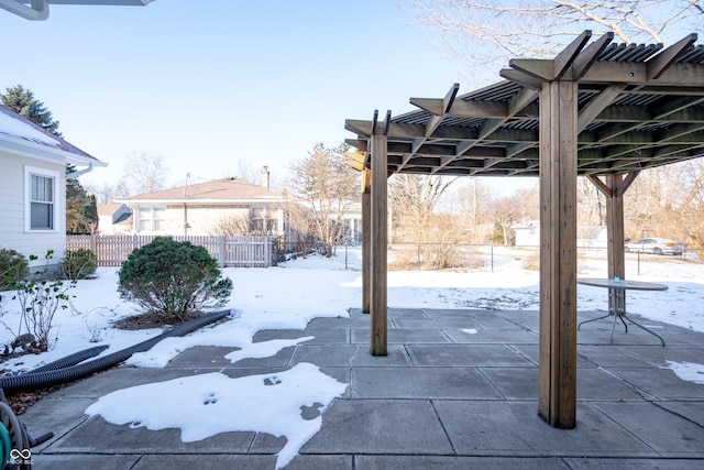 yard covered in snow featuring a pergola