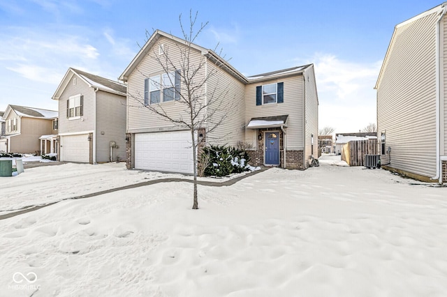 view of front of property with a garage and central AC unit