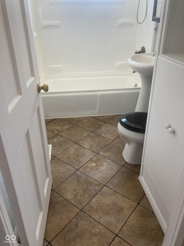 bathroom with shower / tub combination, toilet, and tile patterned flooring