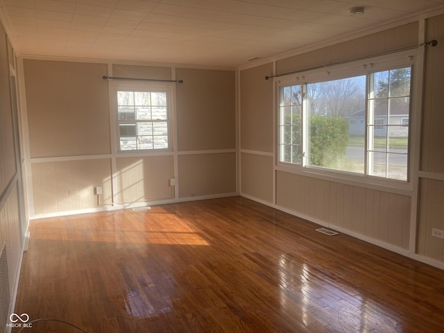 unfurnished room with wood-type flooring and crown molding