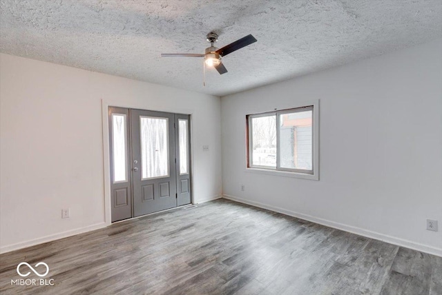 entrance foyer with ceiling fan, a textured ceiling, and hardwood / wood-style floors