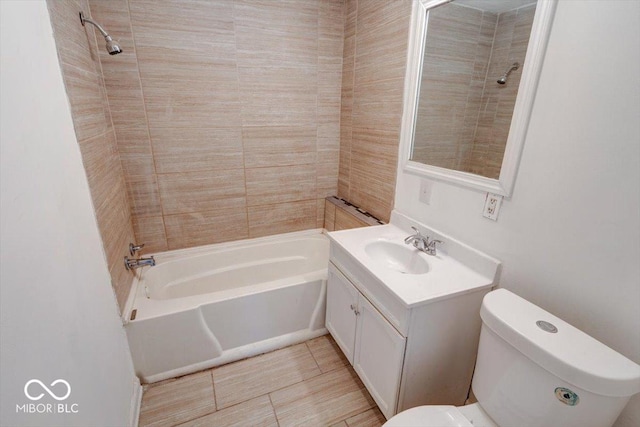 full bathroom featuring toilet, vanity, tiled shower / bath, and tile patterned flooring