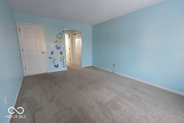 unfurnished bedroom with carpet flooring and a textured ceiling