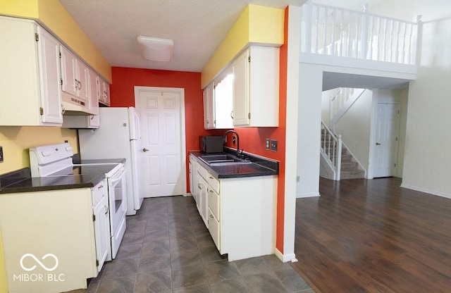 kitchen featuring white electric stove, sink, and white cabinets