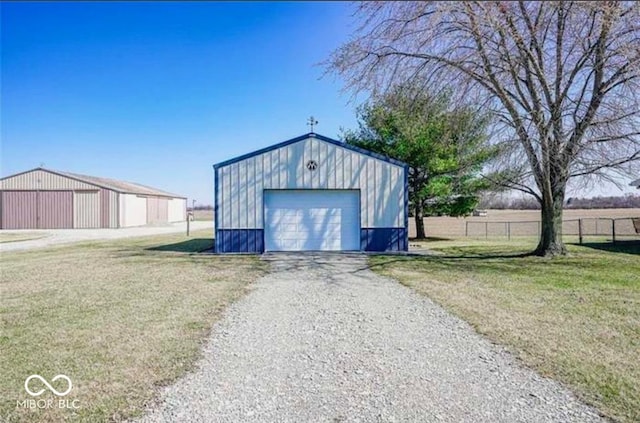 view of outbuilding with a yard and a garage