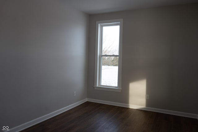 empty room with dark wood-type flooring