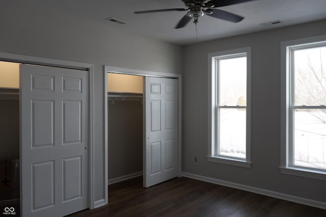 unfurnished bedroom with ceiling fan and dark hardwood / wood-style flooring