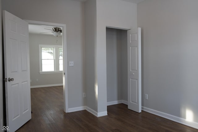 unfurnished bedroom with ceiling fan and dark hardwood / wood-style floors