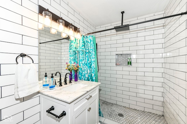 bathroom featuring walk in shower and vanity