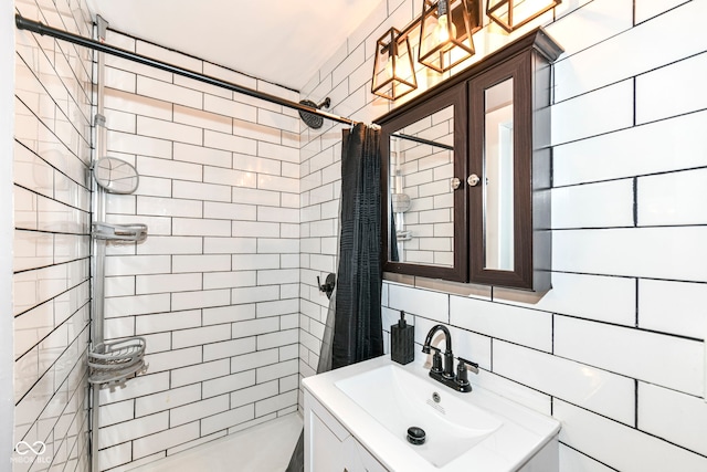 bathroom with vanity, tasteful backsplash, and tile walls