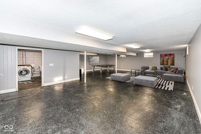 basement with washer / clothes dryer and a textured ceiling