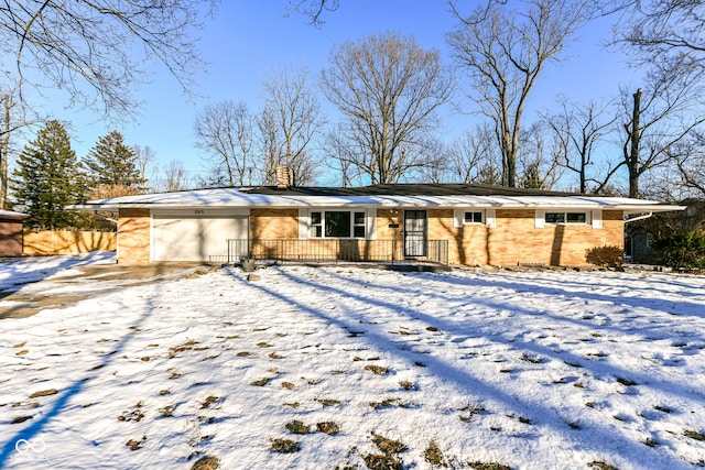 snow covered house with a garage