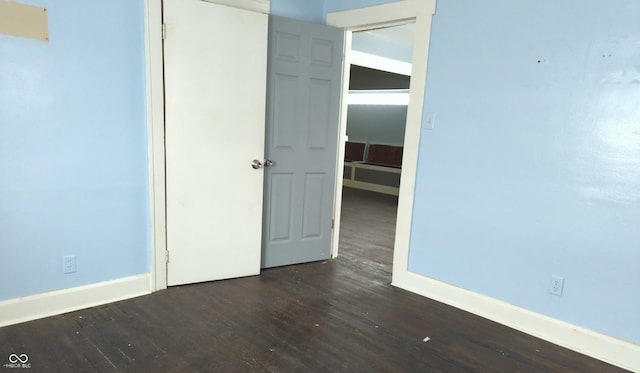 empty room with dark wood-type flooring