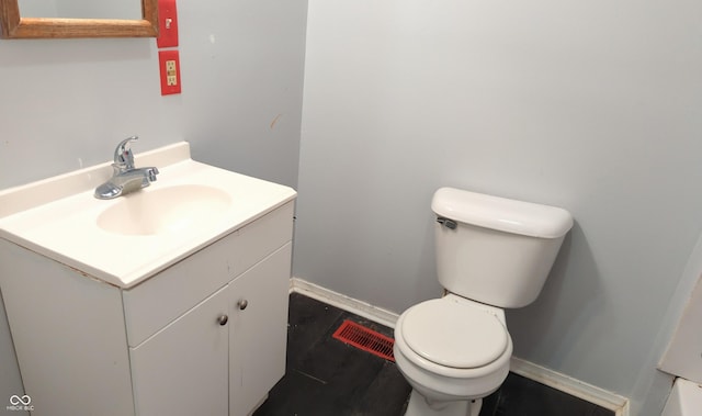 bathroom featuring toilet and vanity