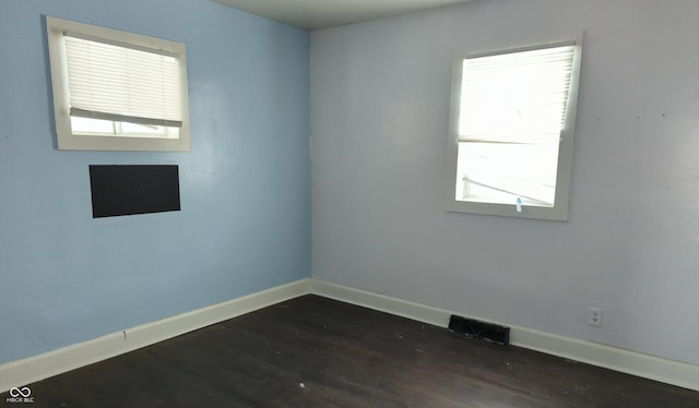 empty room featuring dark wood-type flooring