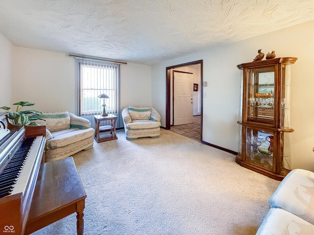 carpeted living room featuring a textured ceiling