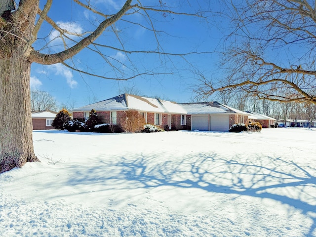 view of snow covered exterior with a garage