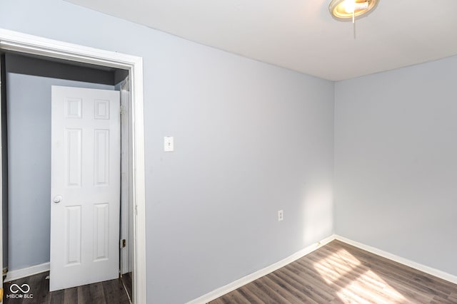 spare room featuring dark hardwood / wood-style flooring