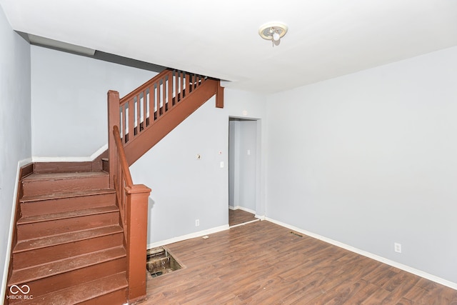 staircase featuring hardwood / wood-style floors