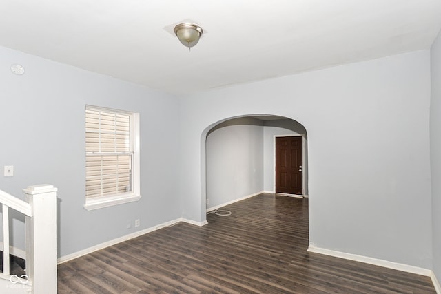 unfurnished room with dark hardwood / wood-style flooring