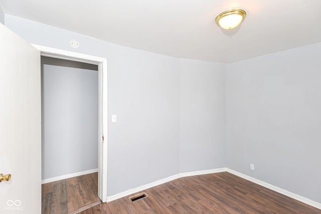 spare room with dark hardwood / wood-style flooring