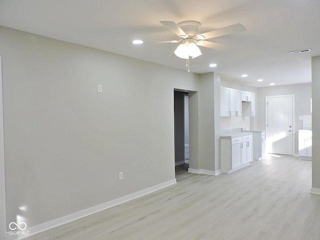 unfurnished living room with light hardwood / wood-style flooring and ceiling fan