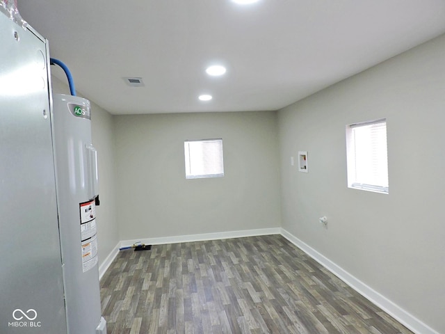 laundry area with washer hookup, a wealth of natural light, and dark hardwood / wood-style floors