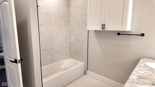 full bathroom featuring toilet, tiled shower / bath combo, and vanity