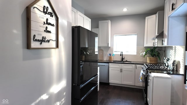 kitchen with extractor fan, white cabinetry, gas range oven, sink, and stainless steel dishwasher