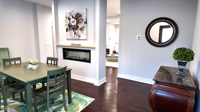 dining space with dark hardwood / wood-style flooring