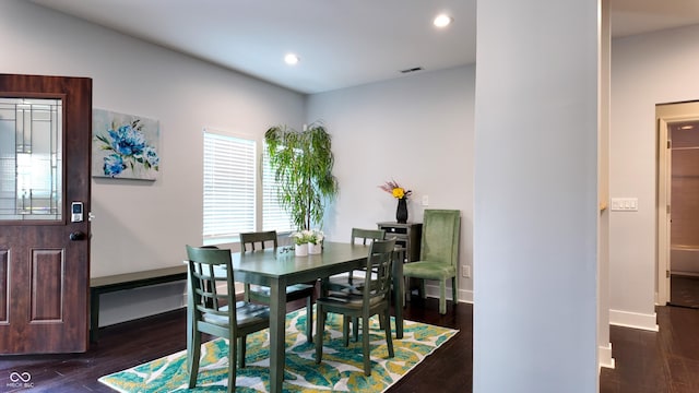 dining space with dark hardwood / wood-style floors