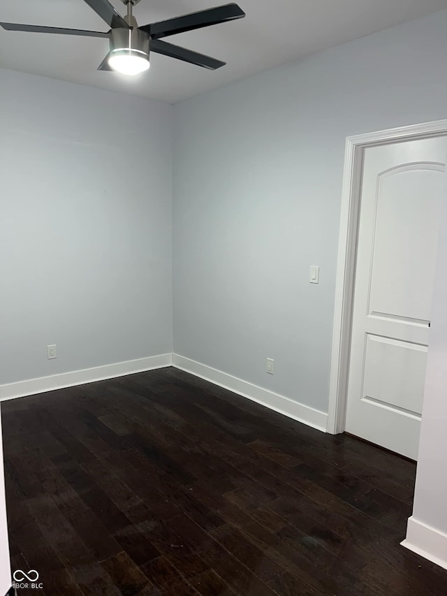 spare room featuring ceiling fan and dark hardwood / wood-style floors