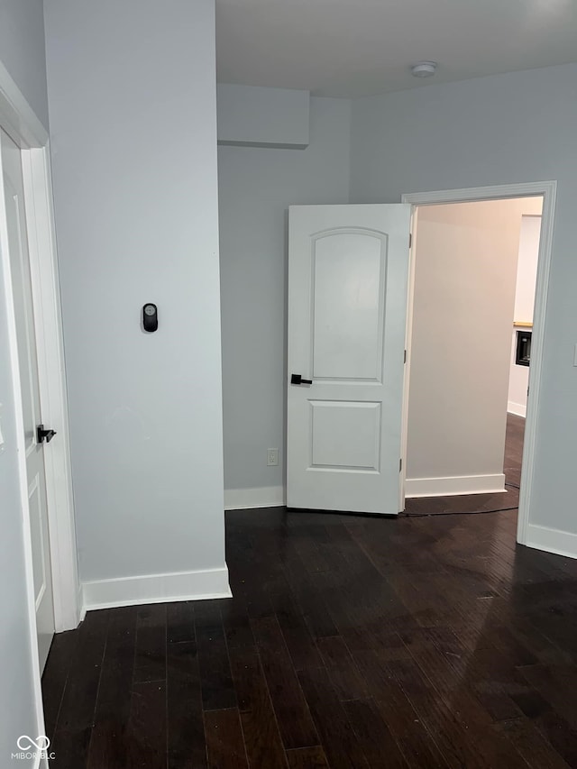 spare room featuring dark hardwood / wood-style floors