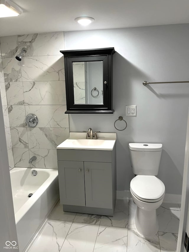 full bathroom with toilet, vanity, and tiled shower / bath