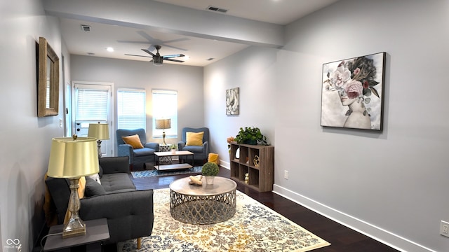 living room with ceiling fan and dark wood-type flooring