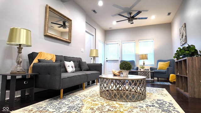 living room with ceiling fan and dark hardwood / wood-style flooring