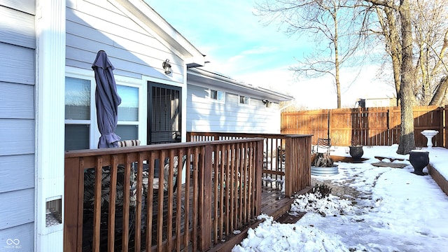 snow covered property featuring a wooden deck