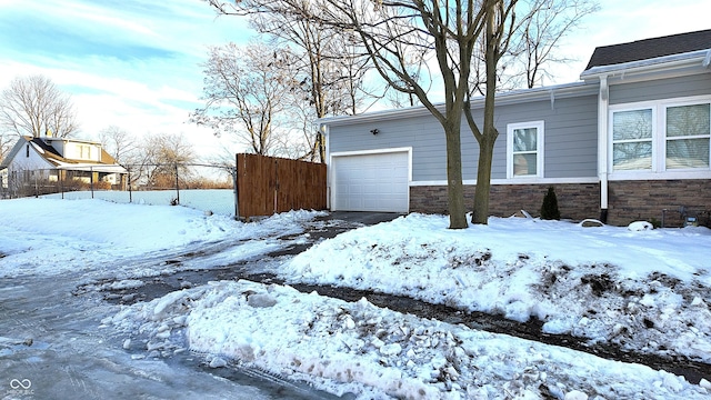 snow covered property featuring a garage