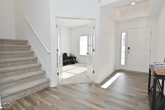 foyer with a raised ceiling