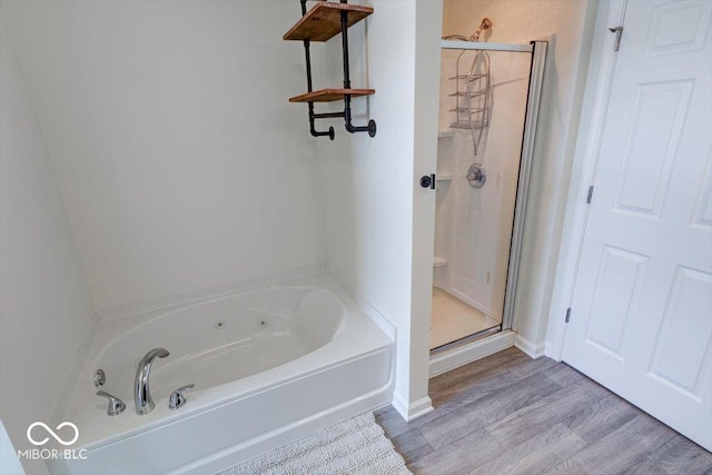 bathroom featuring hardwood / wood-style floors and shower with separate bathtub