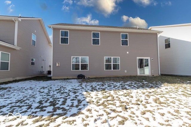 snow covered property featuring central AC