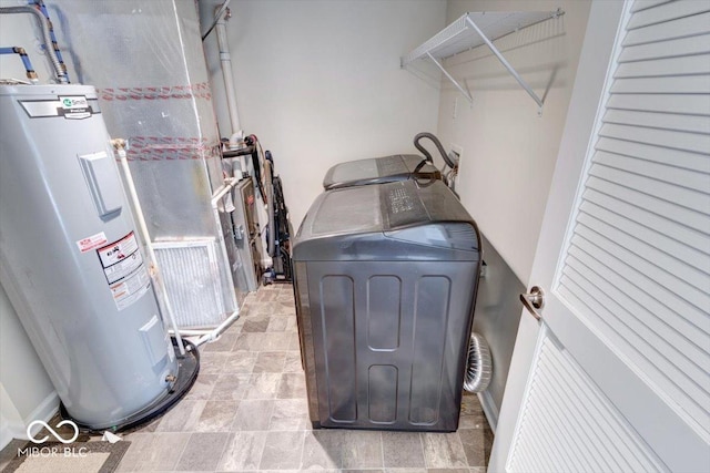 washroom with washer and clothes dryer and electric water heater