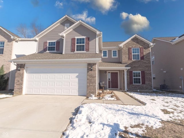 view of front of home featuring a garage and central air condition unit