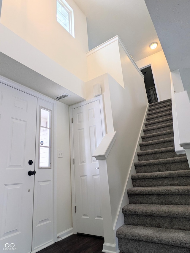 foyer entrance with dark wood-type flooring